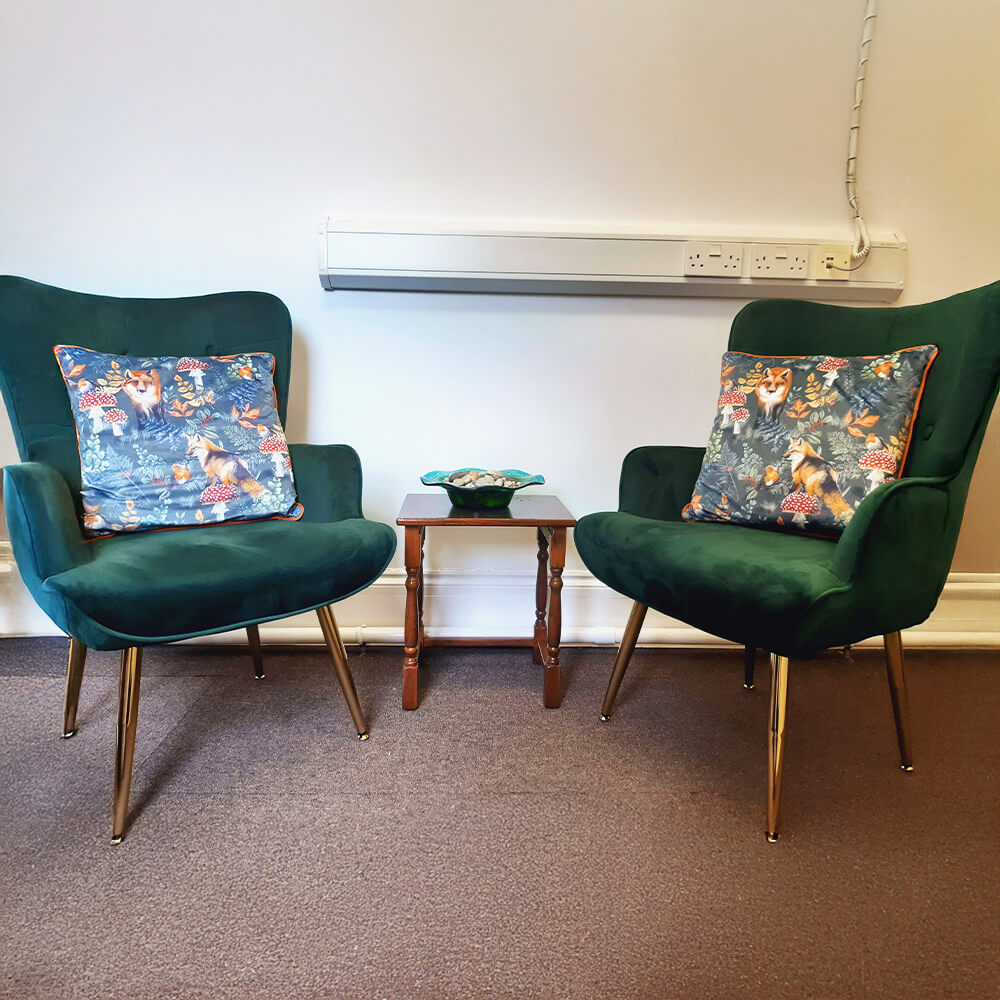 Two green chairs in the middle of the room - Inner Oak Therapy